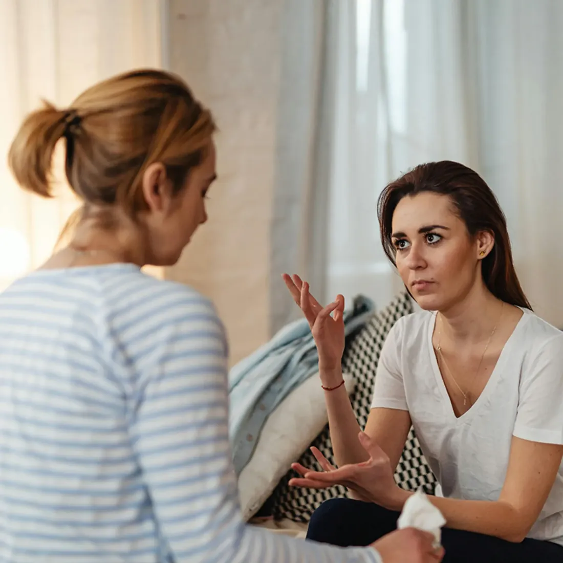 Two women supporting each other in conversation